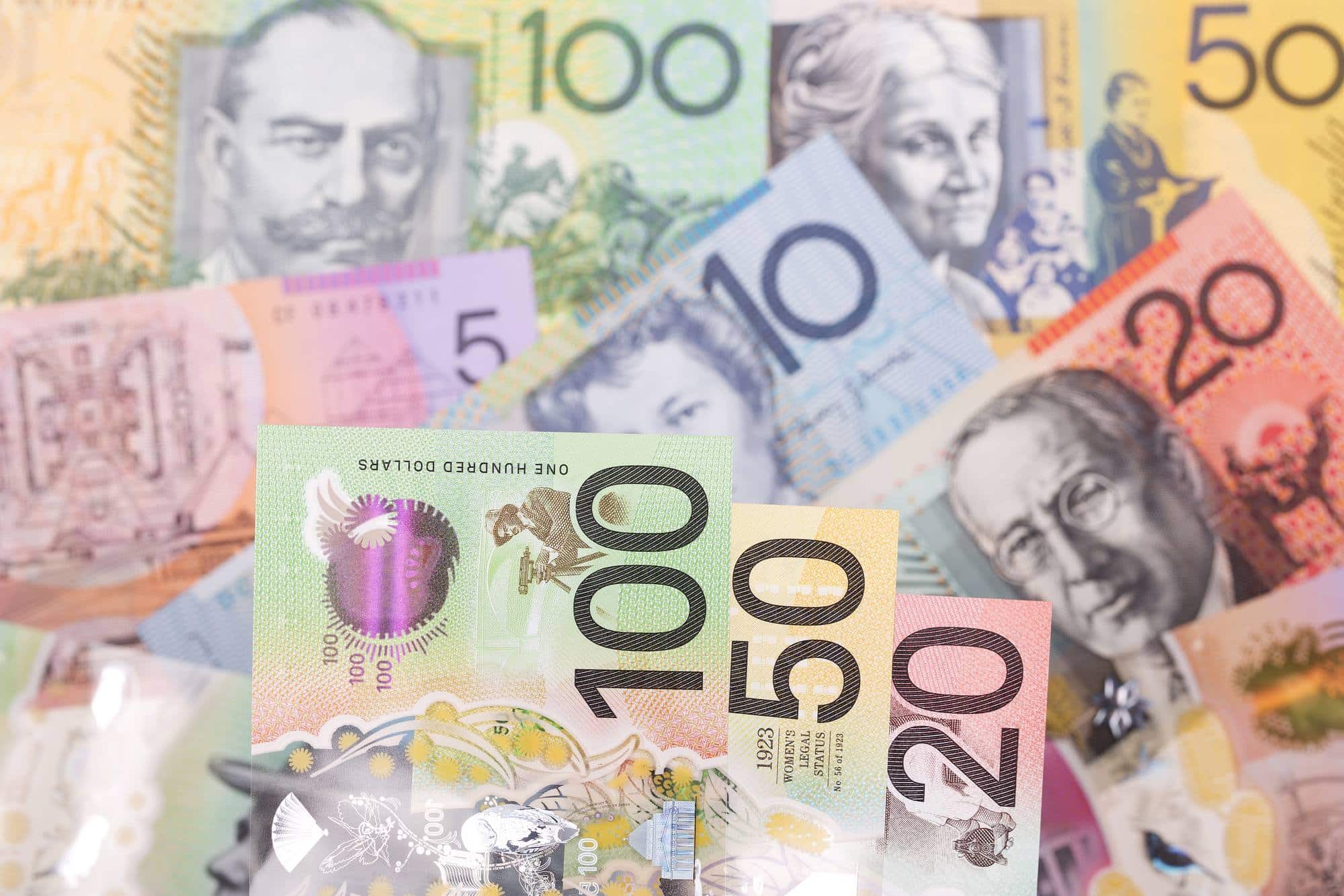 Close-up of various Australian banknotes in different denominations, including 100, 50, 20, 10, and 5 dollar notes.